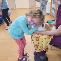 Dziewczynka w okularach przytula się do kota