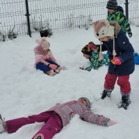 Dzieci bawią się na śniegu.