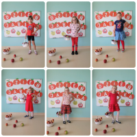 Dzieci pozują do zdjęcia. W rączce trzymają kosz pełen jabłek.